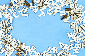 Set of a wooden letters of the English alphabet on wooden blue background 