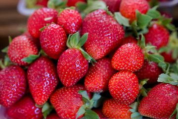fresh red strawberry in the plastic box ready for sell in the fruit market.