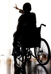 disabled sitting in a wheelchair in the room with dark effect