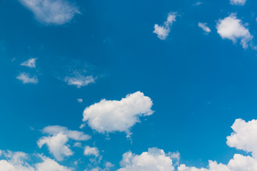 Bright sky blue background. Sky in daylight with beautiful white cloud.