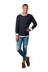 Fototapeta premium Young african american man posing with arms at hip and laughing looking to the front on isolated white background. Ideal for use in architectural designs