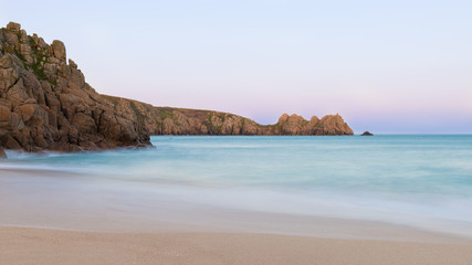 Fototapeta na wymiar Stunning sunset landscape image of Porthcurno beach on South Cornwall coast in England