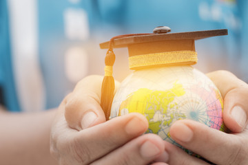 Education in Global, Graduation cap on Businessman holding Earth globe model map with Radar...