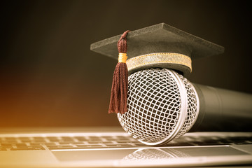 Graduate study or Education knowledge concept: Graduated cap Put on Microphones front of table of...
