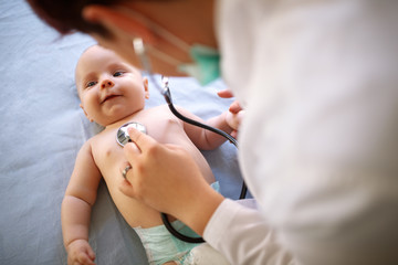 Baby is checking up with stethoscope by pediatrician - obrazy, fototapety, plakaty