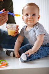 Beautiful baby eating porridge