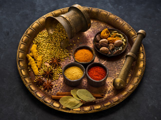 Selection of Indian Spices and seasonings on a metal tray, top view