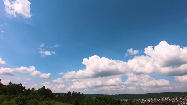 Quickly floating clouds over the field and plain at day