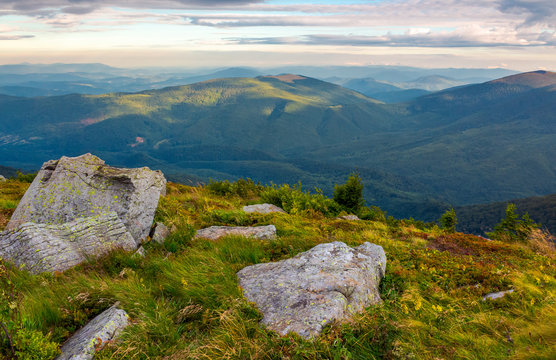 boulders on the edge of hillside. lovely view from Runa mountain, Ukraine. cloudy august morning