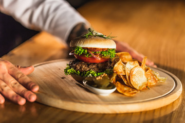 Chef making burger in the kitchen.