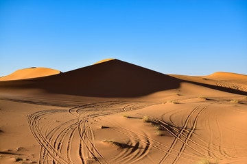 Fototapeta na wymiar A large dune on our way in the Sahara desert. Photograph taken somewhere in the Sahara desert in Merzouga Morocco