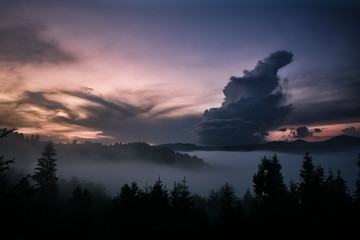 Foggy sunset in mountains