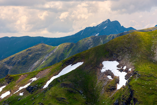 mountain peak behind the peaks. lovely scenery of Fagaras mountains on a cloudy summer day