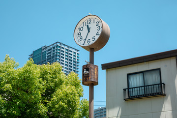 Fototapeta na wymiar A clock with two birds in the kinder yard of Osaka, Japan