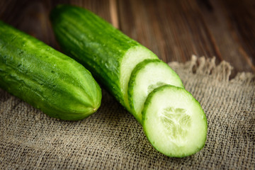 Cucumber on dark wooden background.