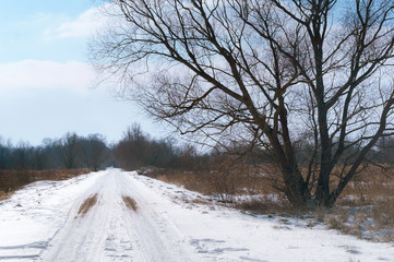 Obraz premium The road is unpaved under snow. Snow-covered roads outside the city.