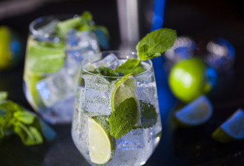 Closeup of mojito cocktails. Ingredients and utensils.