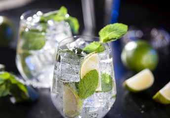 Closeup of mojito cocktails. Ingredients and utensils.