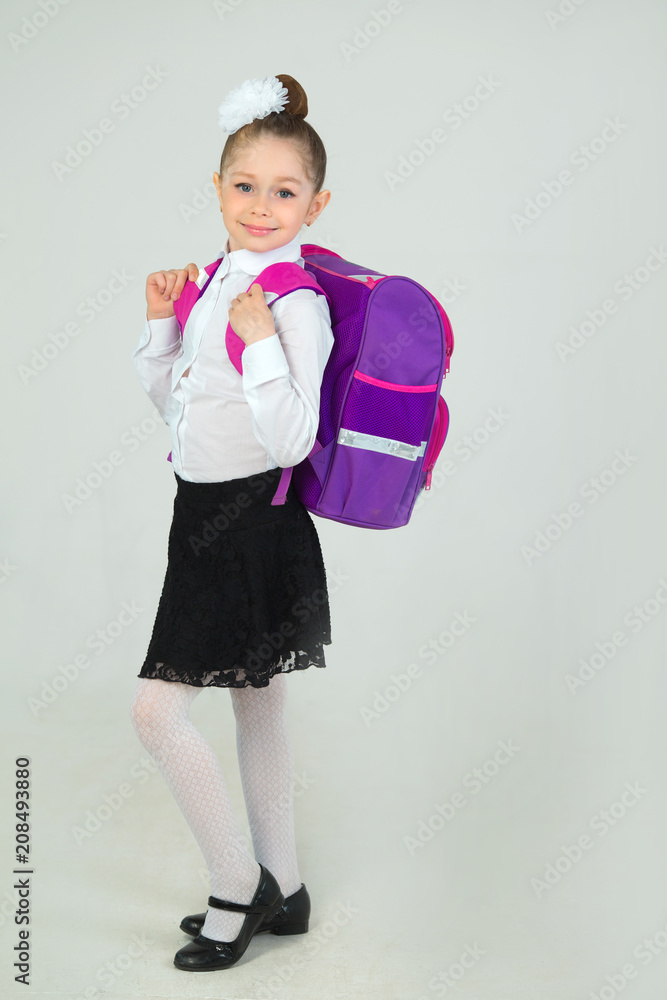 Wall mural beautiful little girl with bow on head and with briefcase on white background