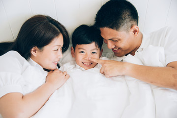 Fototapeta premium Happy aian family lying in bed and sleeping.