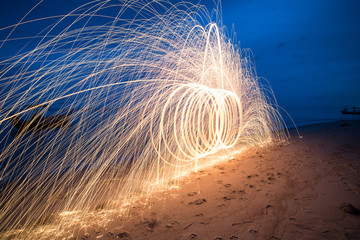 Sparkler firework light on the beach.