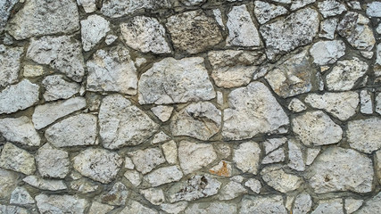 Limestone masonry of ragged irregular stones with dark seams