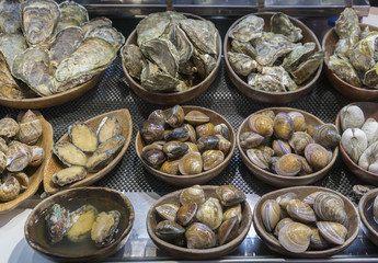 Fresh Abalones , Atlantic surf clam , Oysters and Turbo cornutus prepared for barbecue fire grill on Feng Chia night market , street food market in Taichung , Taiwan