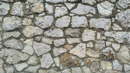 Limestone masonry of ragged irregular stones with dark seams	_2
