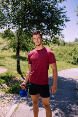 Young nude male fitness model posing outdoor