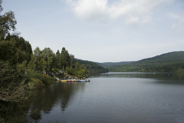 German and foreigner travelers people playing and paddle boat in Schwarzenbachtalsperre Lake at Germany