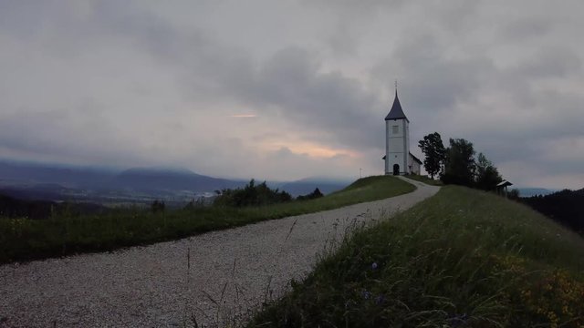 Time lapse sunset at Church of St. Primus and Felician, Jamnik, Slovenia 