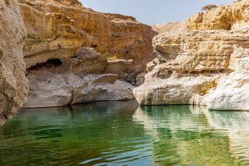 A stream of water in the rocky desert of Oman flowing in a canyon to the oasis of Wadi Bani Khalid - 6