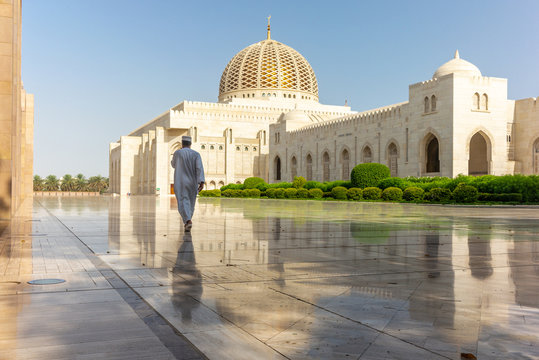 A prayer on his way to the Muscat Grand Mosque in the typical Omani dress early in the morning - 4