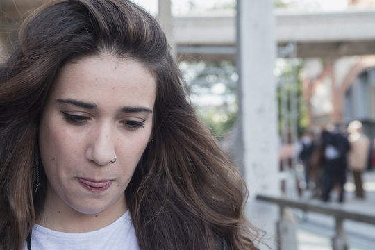 portrait of cute girl with pircing on the nose sticking out her tongue