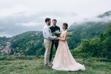 Walking newlyweds in nature. Groom and bride against the background of mountains and the sea. The...