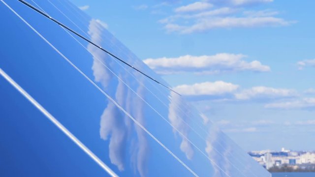 The sky is reflecting in a solar panel under right angle. Ecology Power Conservation Concept.