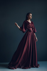 Young elegant girl in burgundy dress