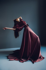 Young elegant girl in burgundy dress