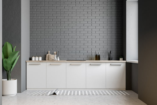 White kitchen counter, gray brick wall