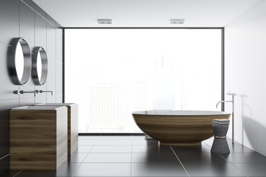 Black tile bathroom interior, wooden tub and sink