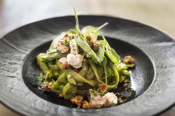 Homemade pasta with spinach and goat cheese