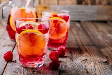 Sparkling Lemon Raspberry Lemonade Sangria in glass on wooden background