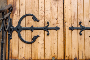 Forged hinge on an ancient wooden door