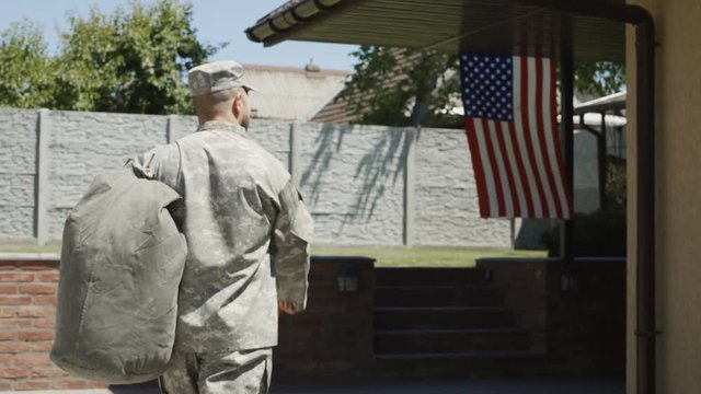 Cheerful woman with children welcoming father and husband from military service looking super excited