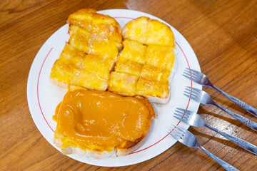 Toast with butter sweetened condensed milk, sugar and thai tea custard bread