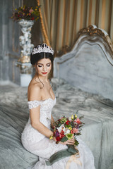 Beautiful fashionable bride, young model brunette woman in stylish wedding dress with naked...