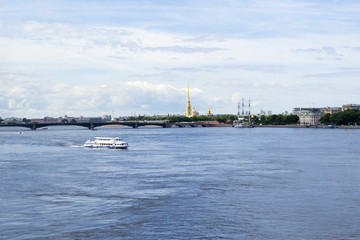 pleasure boat on the Neva river, spire of Peter and Paul fortress, St. Petersburg in summer