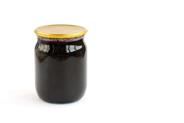 Homemade blueberry jam in glass jar isolated on white background.