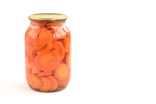 Homemade marinated carrots pickles in jar isolated on white background.