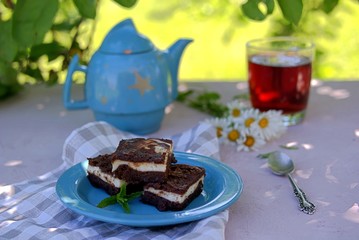 Sweet dessert, chocolate brownie with a layer of cream cheese